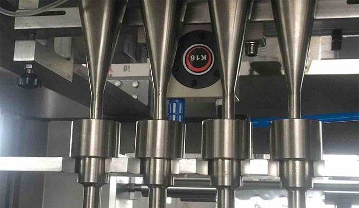 powder filler nozzle and auger assembly
